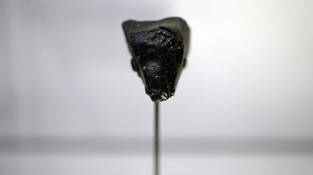 A meteorite, dubbed Black Beauty is one of several meteorites that originated on Mars before landing on Earth. It is seen here in a display case at Maine Mineral and Gem Museum.
