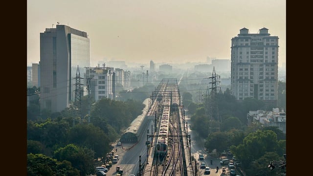 The sun sets over the Millennium City Centre Metro station in Gurugram on Tuesday evening. (Parveen Kumar/HT PHOTO)