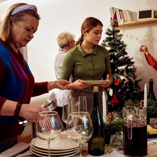 Experts have weighed in on how to prevent an argument brewing at upcoming holiday gatherings. Pictured: Stock image of a family celebrating Christmas.