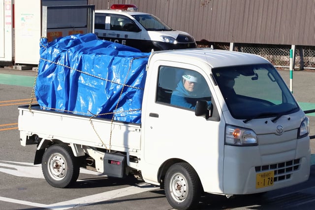 A minitruck carries a bear after it was trapped at a supermarket in Akita, Japan, on December 2, 2024.