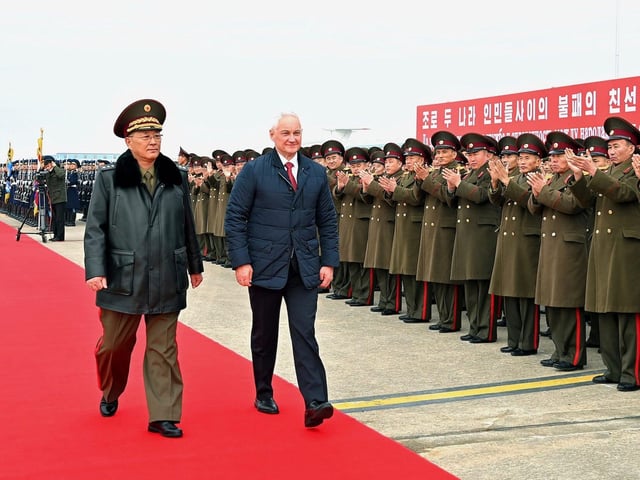 North Korean Defense Minister No Kwang Chol walks with Russia's Defense Minister Andrei Belousov at Pyongyang International Airport, North Korea, on November 30, 2024.
