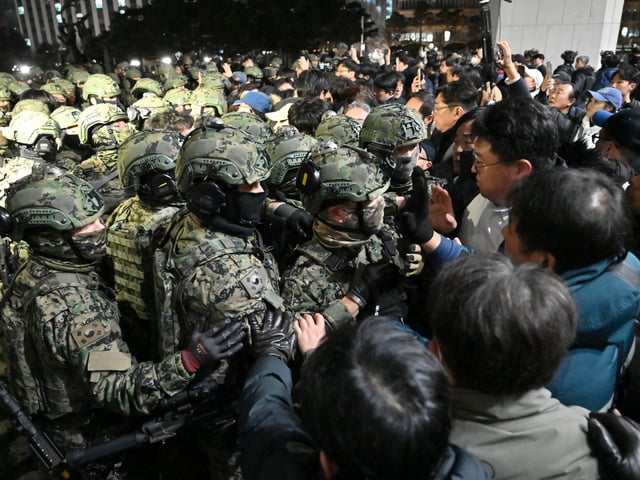Soldiers try to enter the National Assembly building in Seoul on December 4 2024, after South Korea President Yoon Suk Yeol declared martial law. South Korea's President Yoon Suk Yeol on December 3 declared martial law, accusing the opposition of being "anti-state forces" and saying he was acting to protect the country from "threats" posed by the North. (Jung Yeon-je / AFP via Getty)