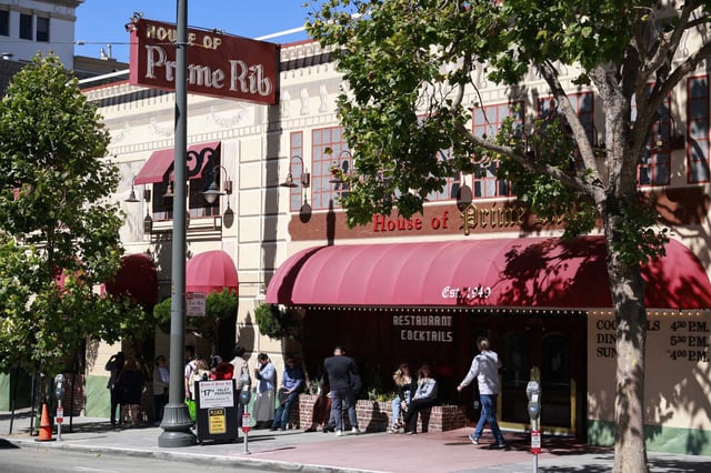 Patrons line up outside of the House of Prime Rib in San Francisco. A former server has sued the restaurant, alleging labor violations.