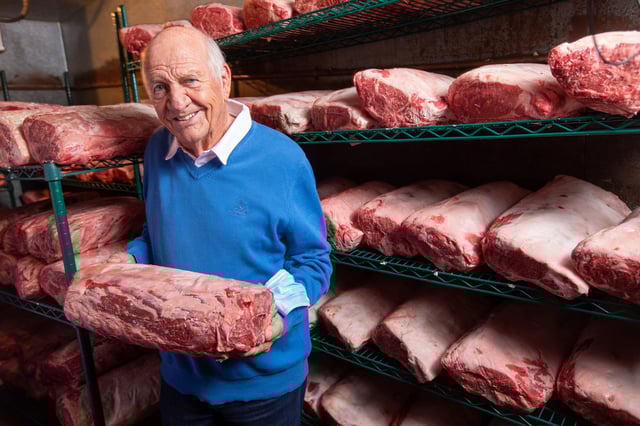 FILE: Joseph Betz, the owner of SF’s House of Prime Rib, poses for a photo in the meat locker of the restaurant in San Francisco on July 6, 2022. A former House of Prime Rib employee has filed a lawsuit against the famed San Francisco steakhouse on allegations of unpaid wages. 