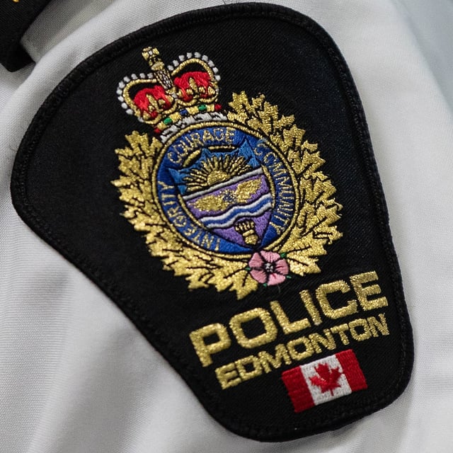 An Edmonton Police Service shoulder badge in Edmonton on Tuesday, Aug 1, 2023. Two people face murder charges in the death of an Edmonton security guard who was patrolling a downtown apartment building. THE CANADIAN PRESS/Jason Franson