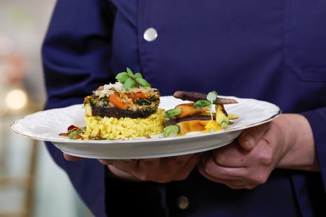 WASHINGTON, DC - JUNE 21: Chef Nina Curtis holds a plate of stuffed portobello mushrooms and creamy saffron-infused risotto, the main course for the state dinner for Thursday’s visit by Indian Prime Minister Narendra Modi during a media preview in the State Dining Room of the White House on June 21, 2023 in Washington, DC. Because the Prime Minister is vegetarian, U.S. first lady Jill Biden hired Curtis, as she specializes in plant-based foods. Before the state dinner Modi will participate in an Oval Office bilateral meeting and press conference with U.S. President Joe Biden and deliver a speech before a joint session of Congress at the U.S. Capitol Building. (Photo by Anna Moneymaker/Getty Images)