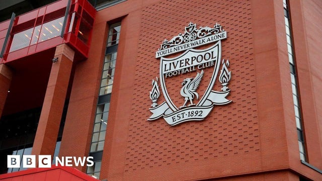 An view of the Liverpool FC club crest on the wall of Anfield stadium, which contains the motto "You'll Never Walk Alone" and the club's founding date of 1892