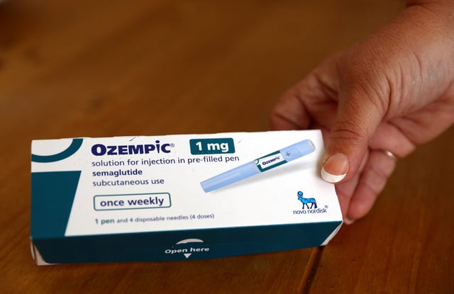 Kim Gradwell poses with a box of Ozempic at her home in Dudley, North Tyneside, Britain on Oct. 31, 2023.