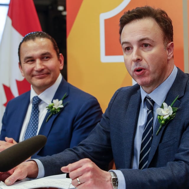 Manitoba Premier Wab Kinew and Finance Minister Adrien Sala speak to media before the provincial budget is read at the Manitoba Legislature in Winnipeg, Tuesday, April 2, 2024.   THE CANADIAN PRESS/John Woods