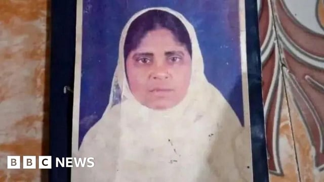 A passport photo of Hamida Banu, wearing a white scarf.