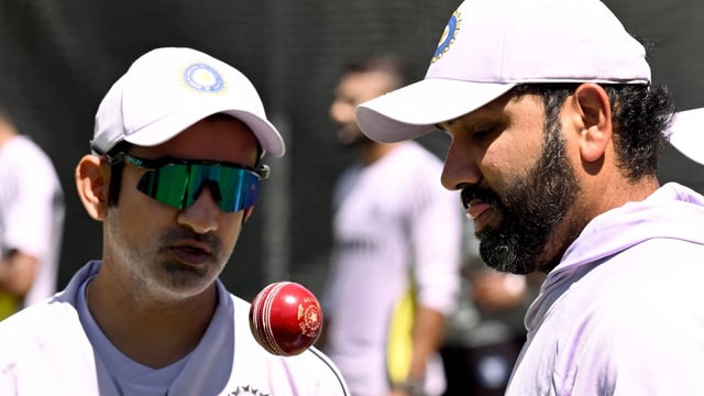 India's coach Gautam Gambhir (L) and captain Rohit Sharma chat in the nets at the Melbourne Cricket Ground