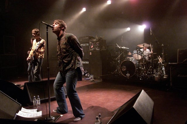 Caption: A chance to see the Gallagher brothers back on stage as Oasis brought fans and ticket touts out in their droves .
Photo: Dave Hogan/Getty.