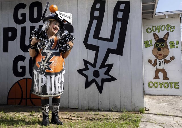 Sovia Lauriano is pictured at her San Antonio home in 2022.  For over 25 years, Lauriano was known among Spurs fans for her undying loyalty to the team and her eclectic handmade Spurs-theme outfits. Lauriano died Saturday, according to reports. 