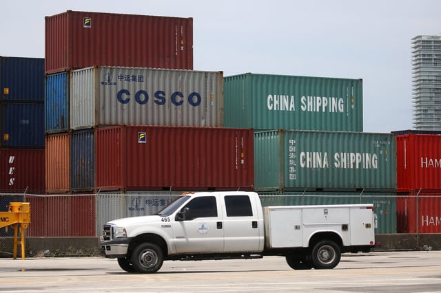 A truck drives past Cosco and China shipping containers in the Port of Miami in Miami, Florida, U.S., May 19, 2016.