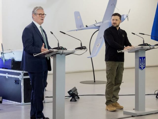 Britain's Prime Minister Keir Starmer (C) and Ukraine's President Volodymyr Zelensky (R) give a press conference after attending a presentation of Ukrainian military drones in Kyiv,  on January 16, 2025. Britain and Ukraine's leaders on January 16, 2025, signed a "landmark" 100-year agreement that pledges strengthening defence ties between the two countries during a visit to Kyiv by Britain's Prime Minister. (Photo by Tetiana DZHAFAROVA / AFP) (Photo by TETIANA DZHAFAROVA/AFP via Getty Images)