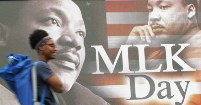 A parade goer walks by a display in honor of Martin Luther King Jr. before the annual MLK Parade through downtown Houston, Saturday, Feb. 10, 2024. The city of Houston and the Black Heritage Society Inc. partnered together to present the rescheduled event that was moved from its original date on MLK Day due to freezing weather. This year&#39;s parade is at 10 a.m Monday in downtown Houston. 
