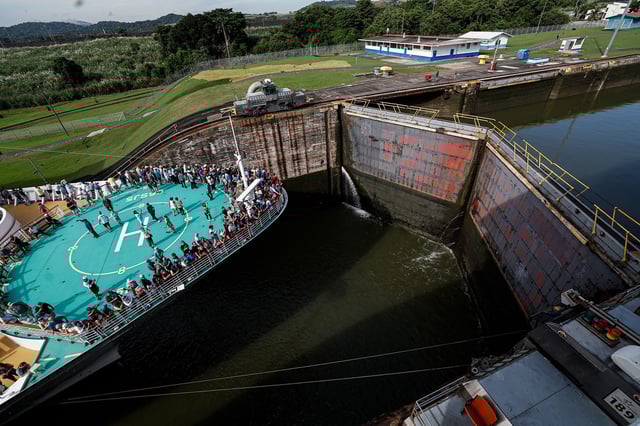 Tourists stand on deck as the cruise ship Brilliance of the Seas enters the Miraflores locks  on October 7, 2024.