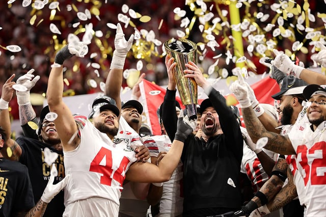 Head coach Ryan Day and the Ohio State Buckeyes hoist the trophy after beating the Notre Dame Fighting Irish.