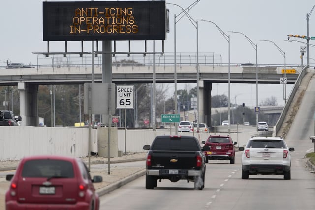 Vehicles pass a sign displaying Winter storm related operations Monday in Houston ahead of predicted several inches of snow and possibly ice in Southeast Texas.