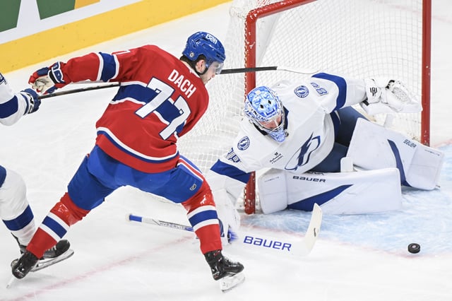 Montreal Canadiens' Kirby Dach (77) moves in on Tampa Bay Lightning goaltender Andrei Vasilevskiy during first period NHL hockey action in Montreal, Tuesday, January 21, 2025. 