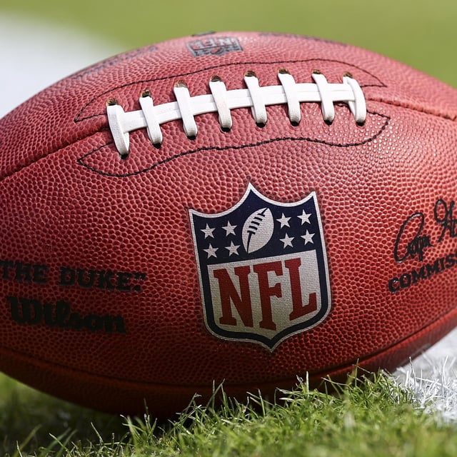 A detail of the NFL Shield logo on a game ball