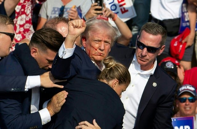 Donald Trump is seen during the Pennsylvania rally assasination attempt beside a Secret Service agent (in sunglasses) identified by US media as Sean Curran