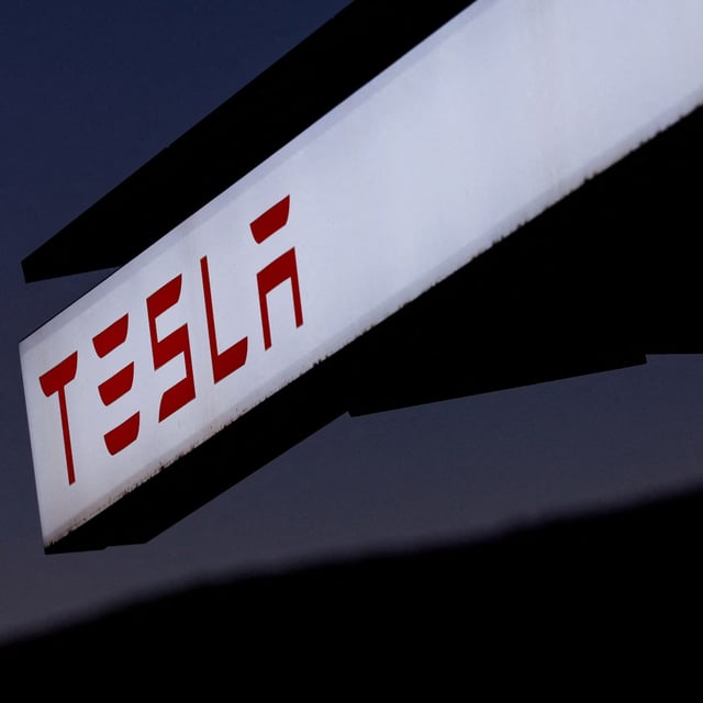 FILE PHOTO: A view of Tesla logo at an electric vehicle charging station between Los Angeles and Las Vegas in Baker, California, U.S., November 19, 2024.  REUTERS/Mike Blake/File Photo