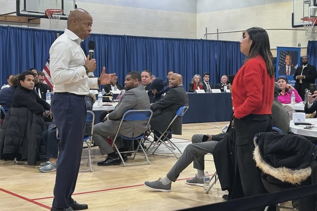 Mayor Eric Adams answers questions at a public hearing in Queens on Wednesday. One questioner asked the mayor for "clarification" on his views on immigration enforcement.