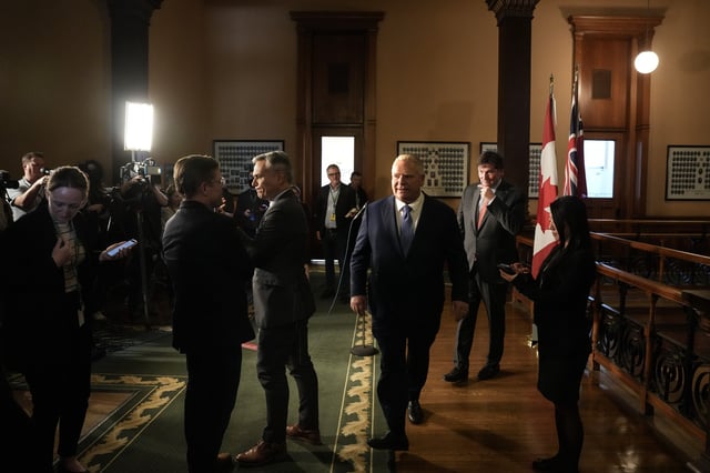 Ontario Premier Doug Ford and Federal Finance and Intergovernmental Affairs Minister Dominic LeBlanc, second from right, make their way back to an office after speaking to media following their meeting at the Ontario legislature, Queen's Park, in Toronto on Tuesday, Jan. 14, 2025. 