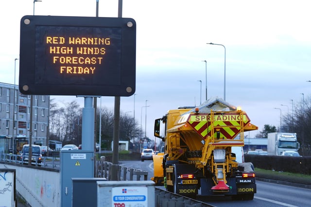 A road sign displays a weather warning for Friday in Edinburgh, UK.