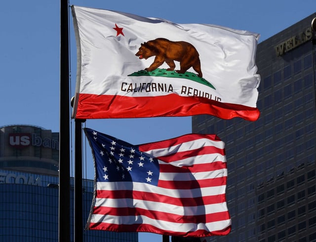 The California State flag and the U.S. flag fly in Los Angeles, California on January 27, 2017. A campaign by Californians to secede from the rest of the country has been revived. 