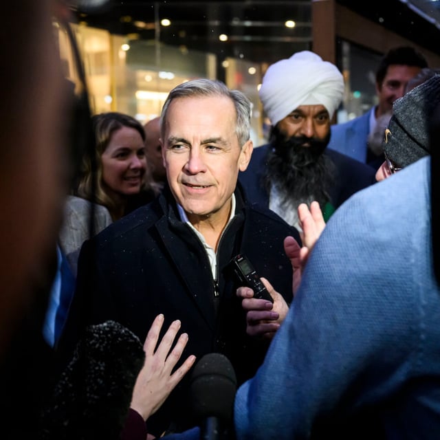 Mark Carney, candidate for the leadership of the Liberal Party of Canada, participates in a scrum with journalists on the sidewalk outside the venue of his campaign event in Ottawa, Thursday, Jan. 23, 2025. THE CANADIAN PRESS/Justin Tang
