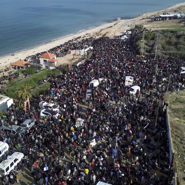 An aerial photograph taken by a drone shows displaced Palestinians gathering with their belongings near a roadblock on the al Rashid Street, as they wait to return to their homes in the northern part of the Gaza Strip, Sunday, January 26, 2025, days after the ceasefire deal between Israel and Hamas came into effect.