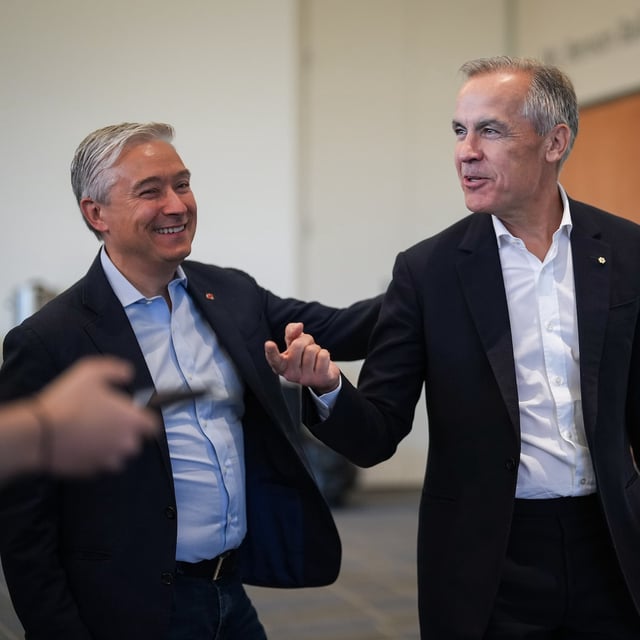 Minister of Innovation François-Philippe Champagne, left, jokes with former Bank of Canada governor Mark Carney as they arrive for the Liberal caucus retreat in Nanaimo, B.C., on Sept. 10.