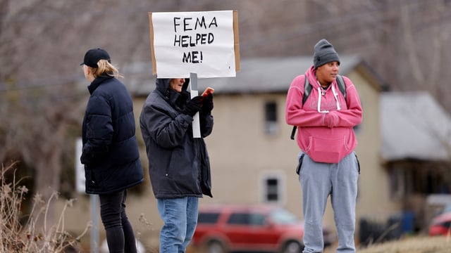 FILE PHOTO: Swannanoa resident Lucy Bickers, who received assistance from FEMA after Hurricane Helene damaged her property, holds a sign in support of the government agency as she waits on the route of visiting U.S. President Donald Trump's motorcade in Swannanoa, North Carolina, U.S., January 24, 2025. (REUTERS/Jonathan Drake/File Photo)