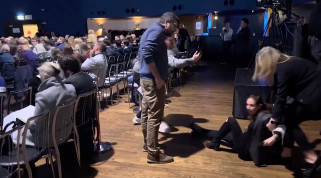 Lior Tibet, an Israel-Irish researcher, is dragged out of a Holocaust memorial ceremony after protesting comments by Irish President Michael Higgins in Dublin, Jan. 26, 2025. (Screenshot)