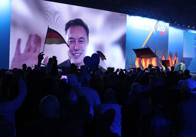 Elon Musk waves and speaks live via a video transmission during a speech by Alice Weidel, chancellor candidate of the far-right Alternative for Germany (AfD) political party, at the AfD election campaign launch rally on Jan. 25, 2025 in Halle, Germany.