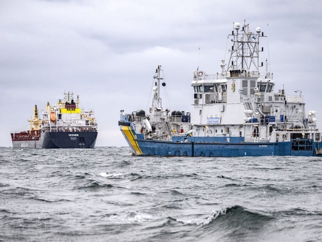 Swedish Coast Guard vessel KBV033 (R) and vessel Vezhen are anchored outside Karlskrona, Sweden, on January 27, 2025, for examination by Swedish authorities. Swedish authorities on Sunday, January 26, 2025 seized the ship suspected of having sabotaged a fibre-optic cable in the Baltic Sea, the prosecutors' office announced. Prosecutors have opened an investigation for "aggravated sabotage" after the undersea cable running between Sweden and Latvia was damaged, said the statement. (Photo by Johan NILSSON / TT News Agency / AFP) / Sweden OUT (Photo by JOHAN NILSSON/TT News Agency/AFP via Getty Images)