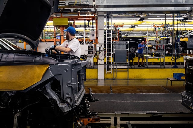 A worker installs an engine at the General Motors assembly plant in Fort Wayne, Indiana, on April 9, 2024.