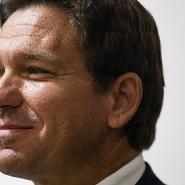Florida Governor Ron DeSantis stands to the side of the stage before speaking during a campaign event with Republican nominee for U.S. Senate Bernie Moreno on November 1, 2024 at he Spartan Northwood Warehouse in Northwood, Ohio.