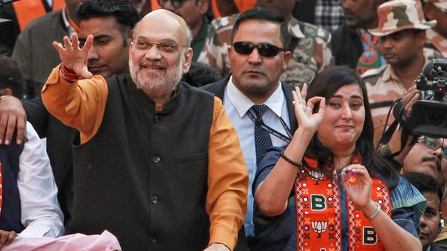Union home minister and BJP leader Amit Shah with party MP Bansuri Swaraj during a roadshow in support of party candidate Neeraj Basoya ahead of Delhi assembly election in New Delhi on Tuesday