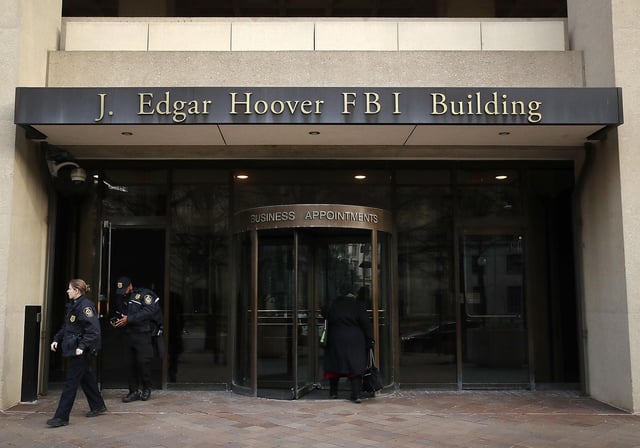 Law enforcement officers walk out of the J. Edgar Hoover FBI Building on January 28, 2019, in Washington.
