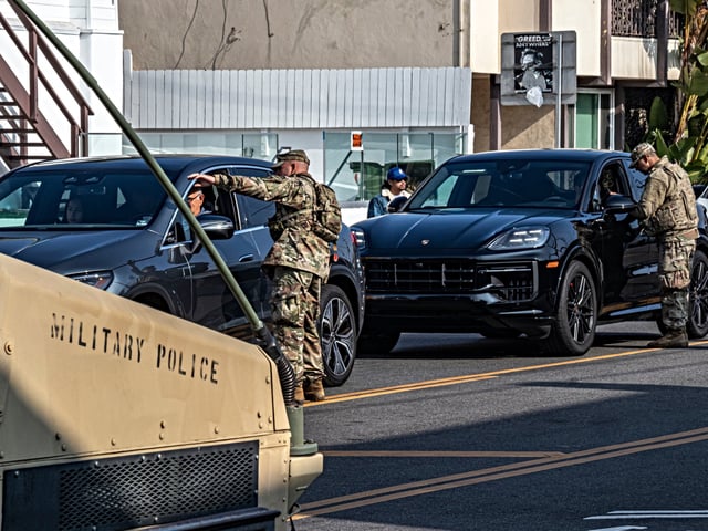 National Guard diverting pedestrians and cyclists from entering Pacific Palisades and Pacific Coast Highway during the Palisade Fire, January 19, 2025. Santa Monica, Los Angeles, California