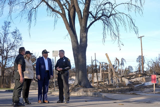 President Donald Trump and first lady Melania Trump walk with members of the Los Angeles Fire Department as they tour the Pacific Palisades neighborhood on Jan. 24, 2025.