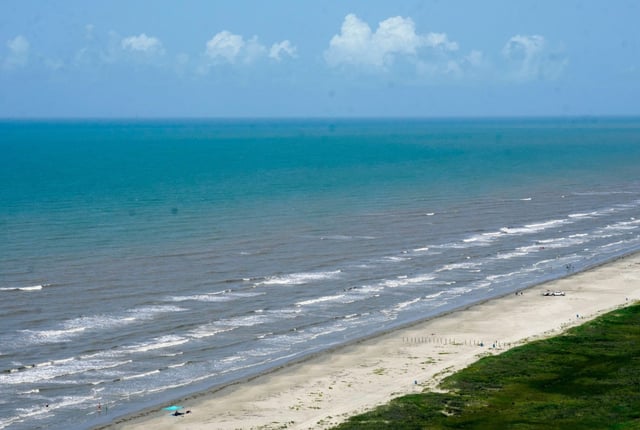 FILE – The water in the Gulf of Mexico appears bluer than usual off of East Beach, Saturday, June 24, 2023, in Galveston, Texas.  (Jill Karnicki/Houston Chronicle via AP, File)