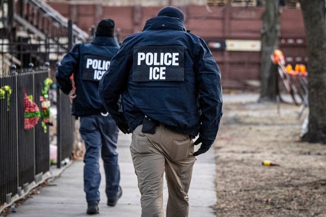 US Immigration and Customs Enforcement agents walk down a street during a multi-agency targeted enforcement operation in Chicago on Jan. 26, 2025.