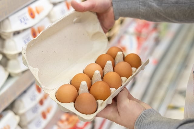 A shopper checks eggs in a supermarket.