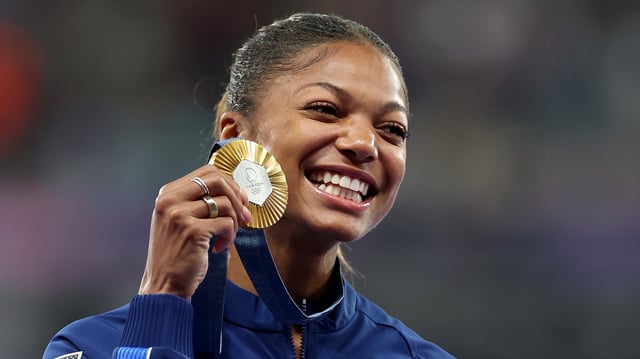 Gold medalist Gabrielle Thomas of Team United States celebrates on the podium during the Women&#39;s 200m medal ceremony on day twelve of the Olympic Games Paris 2024 at Stade de France on August 07, 2024 in Paris, France.