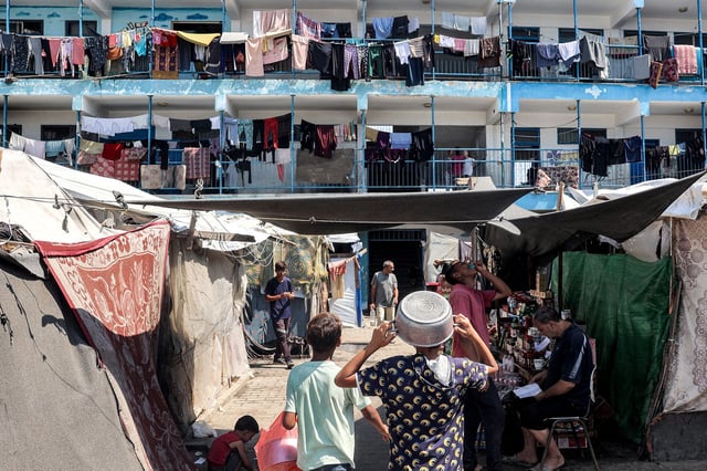 TOPSHOT - An overview shows a make-shift camp for people displaced by conflict at a school run by the UNRWA in Deir el-Balah in the central Gaza Strip on September 9, 2024 amid the ongoing war in the Palestinian territory between Israel and Hamas. (Photo by Eyad BABA / AFP) (Photo by EYAD BABA/AFP via Getty Images)