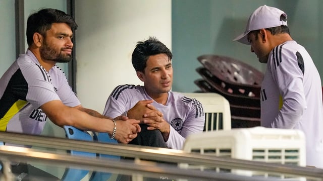 India's Abhishek Sharma, center, is seen with Rinku Singh, left, after the former hurt his ankle during a practice session ahead of the second T20I cricket match between India and England